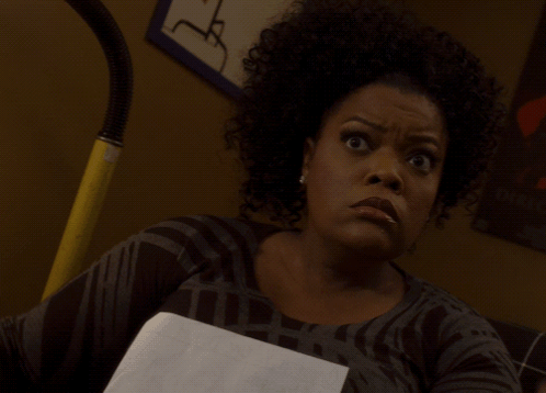 Woman With Curly Hair Holding Paper GIF