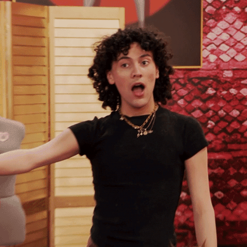 Woman With Curly Hair In Black Shirt And Necklace GIF