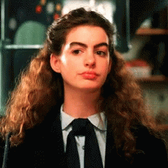 Woman With Curly Hair in Black Suit and Tie