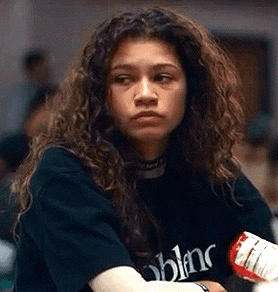 Woman With Curly Hair In Black T-Shirt Holding Bottle GIF