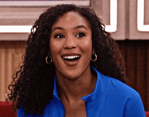 Woman with Curly Hair in Blue Shirt and Earrings