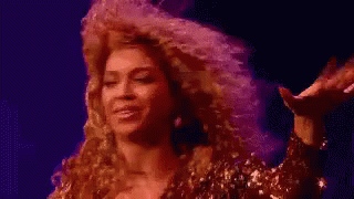 Woman With Curly Hair In Front Of Purple Background Saying Some GIF