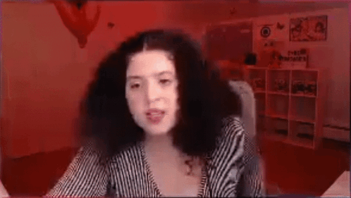 Woman With Curly Hair In Front Of Red Background GIF