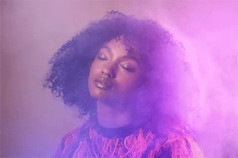 Woman with Curly Hair in Purple Smoke