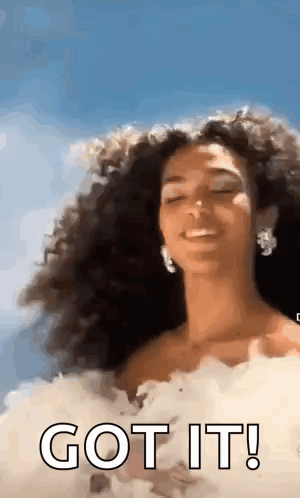 Woman With Curly Hair In White Dress Smiling GIF