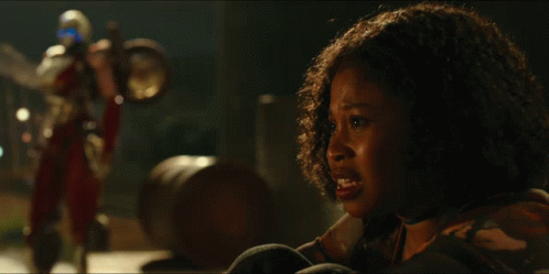 Woman With Curly Hair Looking At A Robot GIF