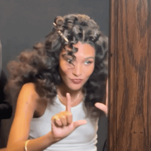 Woman With Curly Hair Making Funny Face GIF