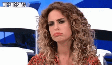 Woman With Curly Hair Making Funny Face In Red Dress GIF