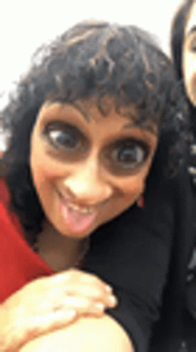 Woman With Curly Hair Making Funny Face Next to Another Woman