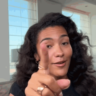 Woman With Curly Hair Pointing At Camera GIF