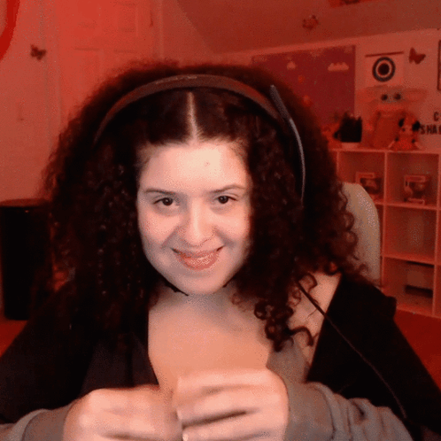 Woman With Curly Hair Smiling in Headphones