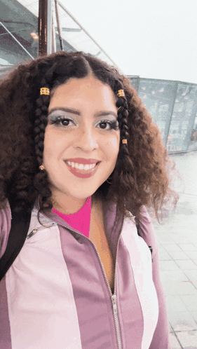 Woman With Curly Hair Smiling In Pink Shirt GIF