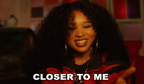 Woman With Curly Hair Smiling With Words Closer to Me