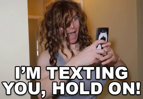 Woman With Curly Hair Taking Selfie Saying I'm Texting You Hold On