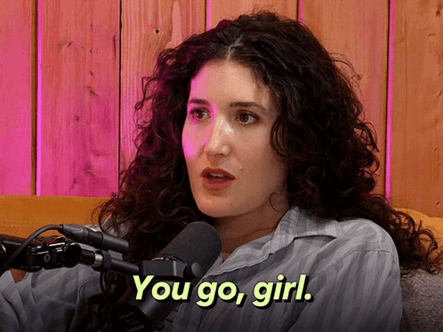 Woman with Curly Hair Talking Into Microphone