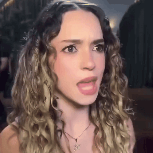 Woman With Curly Hair Wearing Necklace With Star GIF