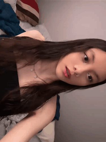 Woman with Dark Hair in Black Tank Top and Necklace