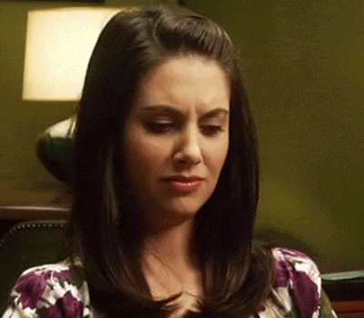 Woman With Dark Hair In Purple Floral Shirt GIF