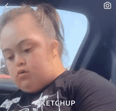 Woman with Down Syndrome Sitting in Car with Ketchup on Face