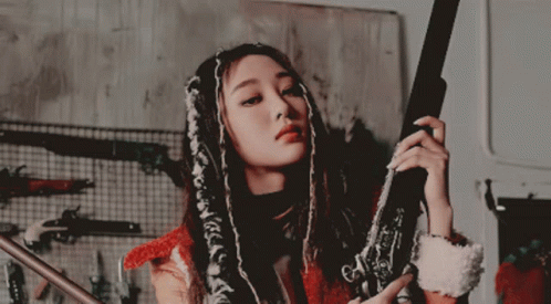 Woman With Dreadlocks Holding Gun