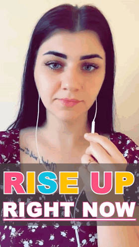 Woman With Ear Buds Holding Phone In Front Of Rise Up Right Now Sign GIF