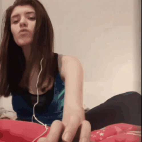 Woman With Earbuds Lying on Bed