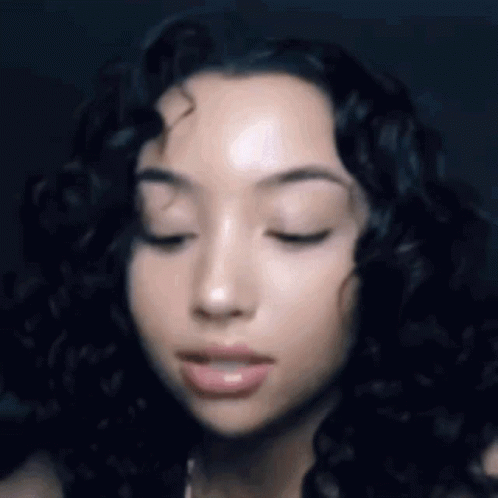 Woman With Eyes Closed And Curly Hair GIF