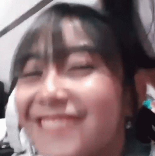 Woman With Eyes Closed And Hair In Bun GIF