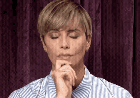 Woman With Eyes Closed And Hands On Chin GIF