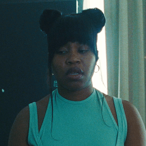 Woman With Eyes Closed In Blue Tank Top And Earrings GIF