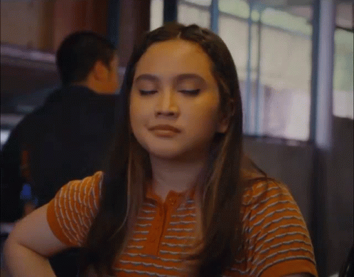 Woman With Eyes Closed in Striped Shirt