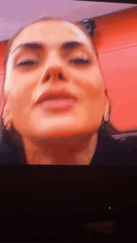 Woman with Eyes Closed on Red Background