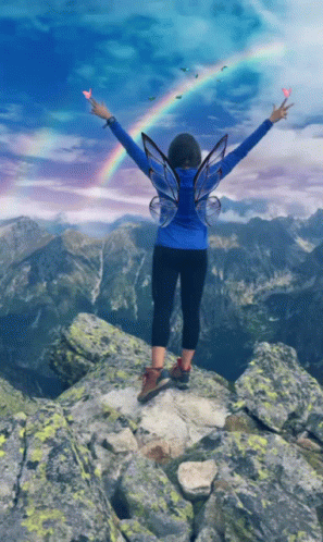 Woman With Fairy Wings Arms Outstretched on Mountain