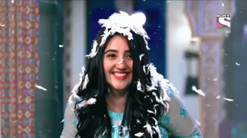 Woman With Feather Headpiece Smiling GIF