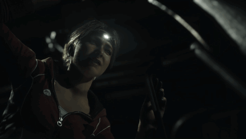 Woman With Flashlight On Head Looking Down GIF