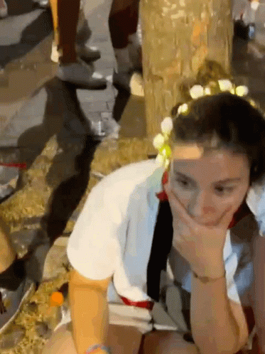 Woman With Flower Crown Covering Mouth GIF