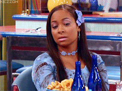 Woman With Flower In Hair Sitting At Table GIF