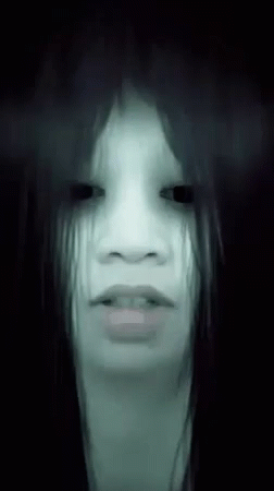 Woman With Ghostly Look In Dark GIF