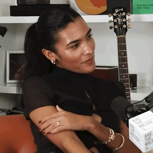 Woman With Gibson Guitar And Sign Saying And The World Wrote The Lyrics GIF