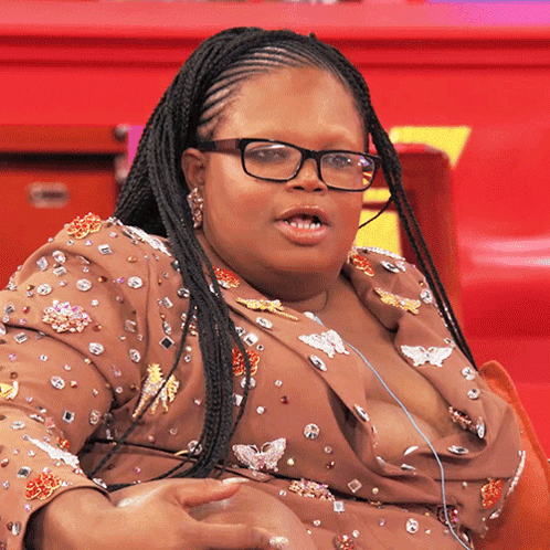 Woman With Glasses and Braided Hair Sitting on Red Chair