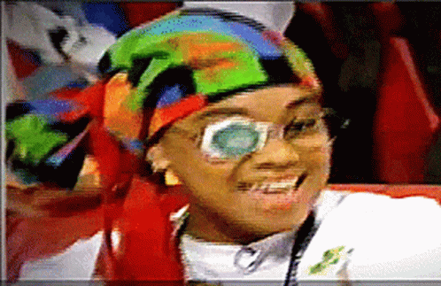 Woman With Glasses and Colorful Head Scarf Smiling