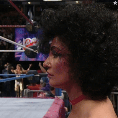 Woman With Glasses and Feathered Sleeves Saying Phe-