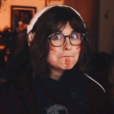 Woman with Glasses and Headphones Bloodied Face