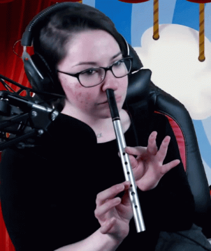 Woman With Glasses And Headphones Playing Flute GIF