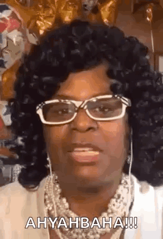 Woman With Glasses And Necklace Making A Face GIF