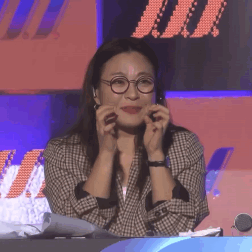 Woman With Glasses And Plaid Jacket Hands On Face GIF