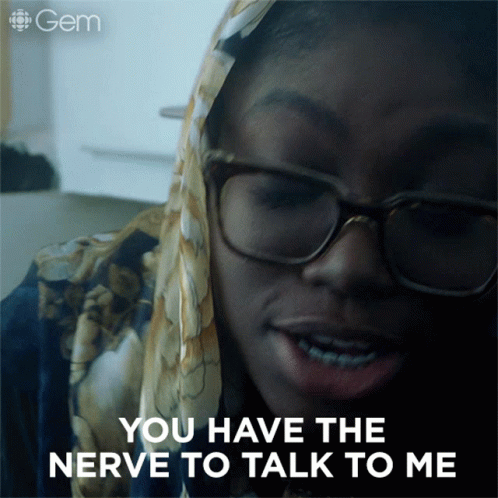 Woman with Glasses and Scarf Saying You Have Nerve