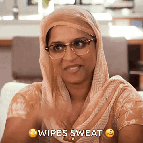 Woman With Glasses And Scarf Wiping Sweat GIF