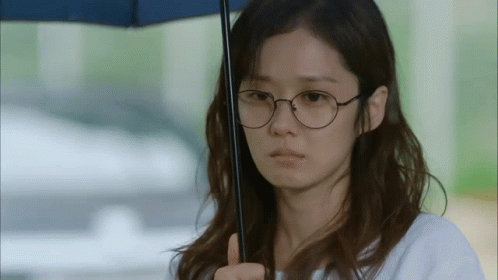 Woman with Glasses and Umbrella Making Funny Face