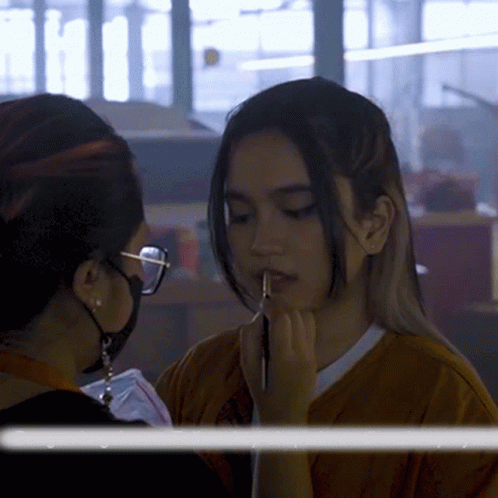 Woman With Glasses Applying Makeup to Another Woman